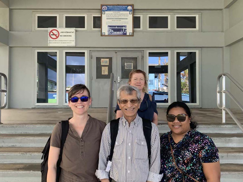 Dr. Ashok Vaswani (middle front) with Nurse Vanissa Toka, Dr. S. Robin Elgart, and Michelle Yamaguchi outside Ebeye Hospital 