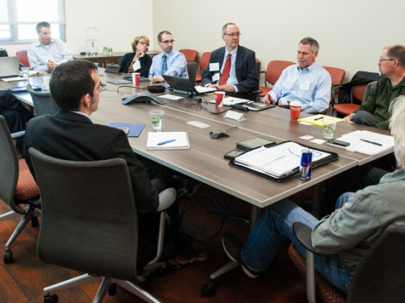 People sitting around a table in a meeting room.