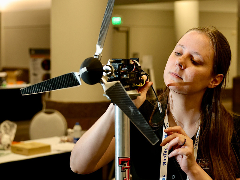 Person working on a wind turbine model