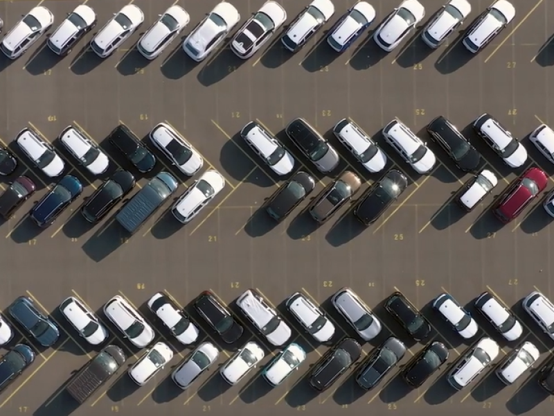 Aerial view of vehicles in a parking lot. 
