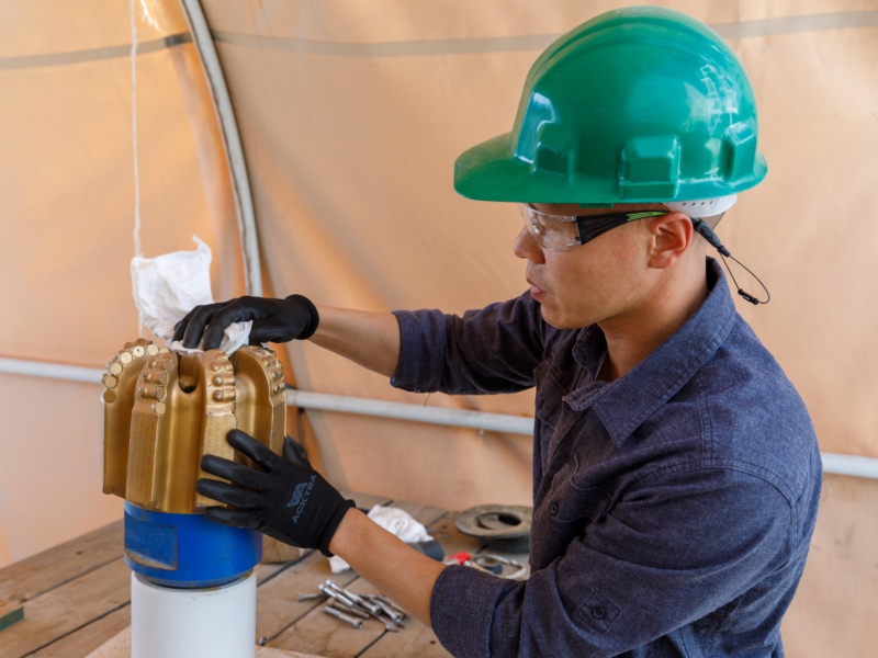 Sandia staff member works with a PDC drill bit