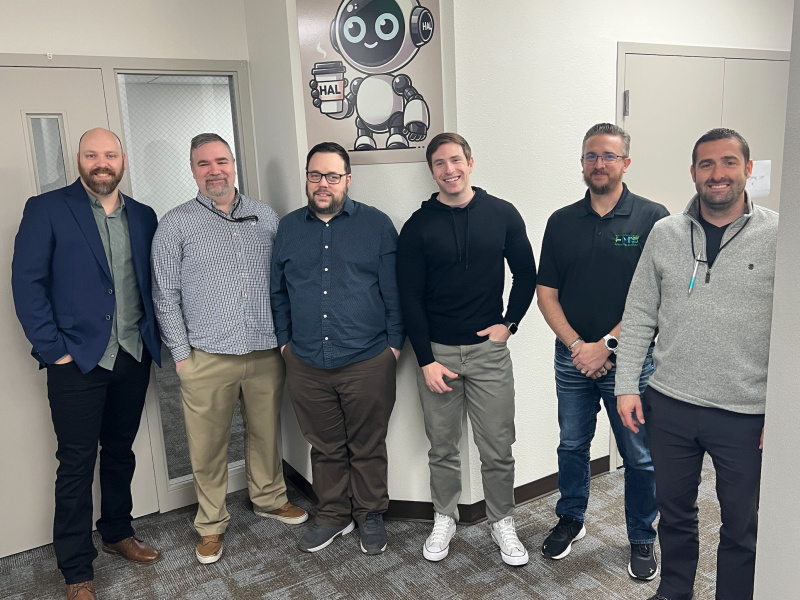 A group of employees smiling for a group photo