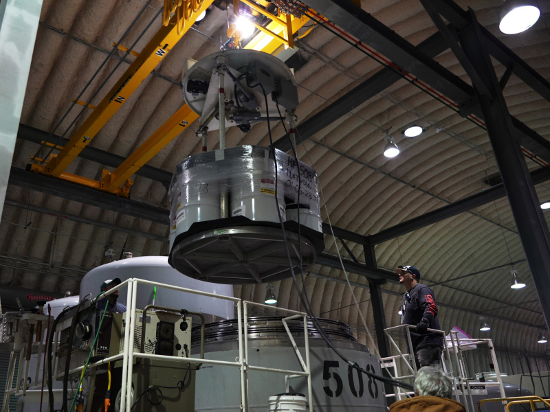 An employee using a large machine to load waste