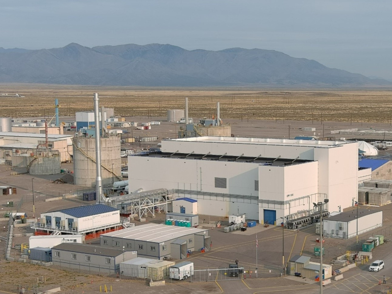 Aerial view of a large white treatment building with lots of other smaller buildings around it