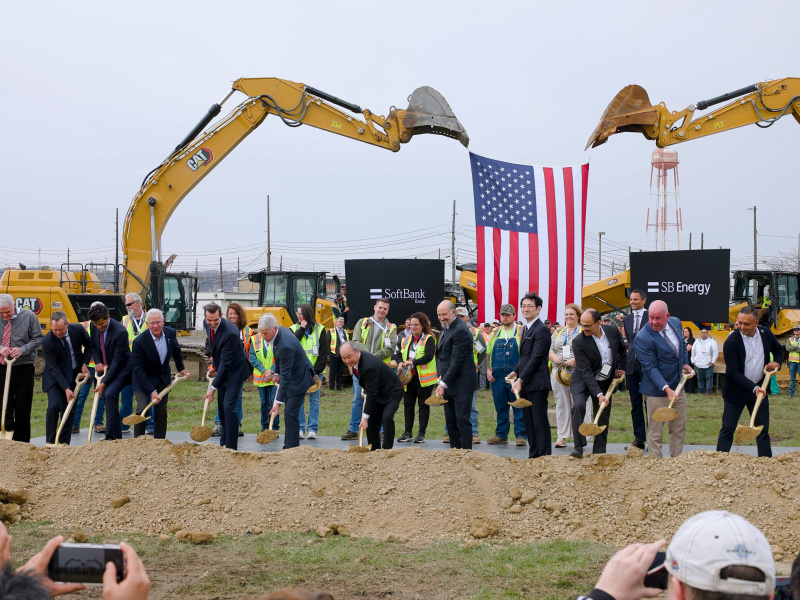 A group of professionals holding shovels while participating in a groundbreaking ceremony at the Portsmouth Side