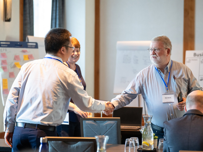 Two men shake hands at conference