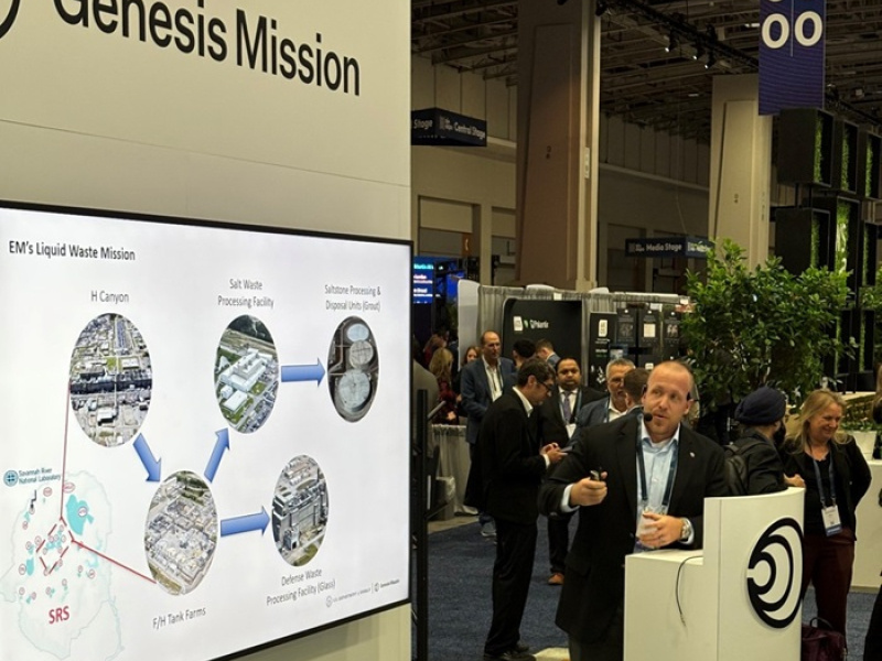A professional giving a presentation at an Expo on the DOE Genesis Mission