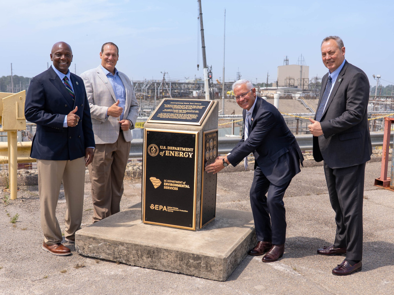 Four Department of Energy Officials pose for a picture outside at the Savannah River Site