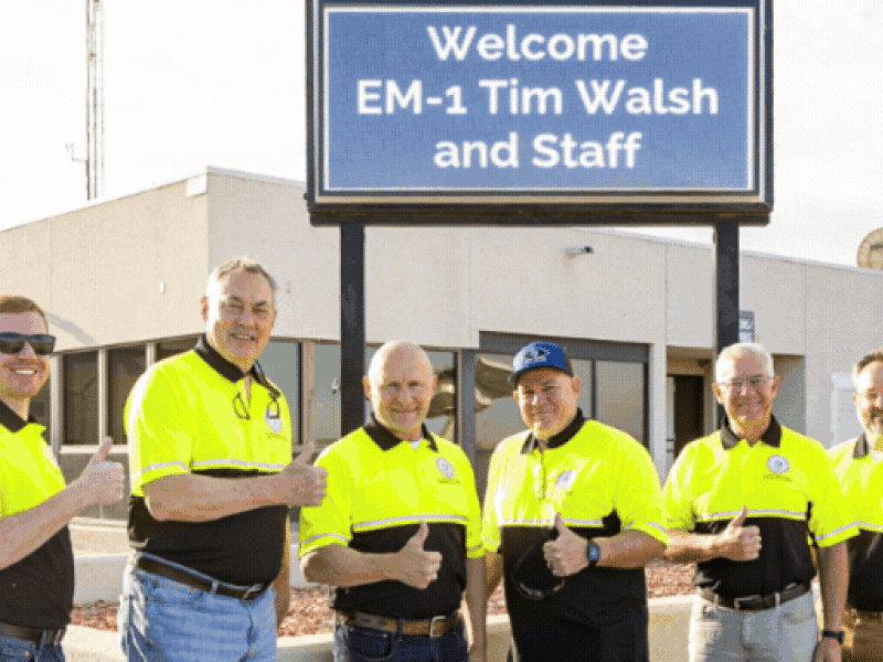 Rotating set of images of EM leadership touring the WIPP site