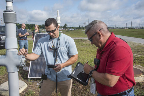 Remote operators take readings of a microblower used to remove underground chemical solvents.
