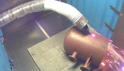 The "snake arm" robot cuts through a quarter inch of steel.
