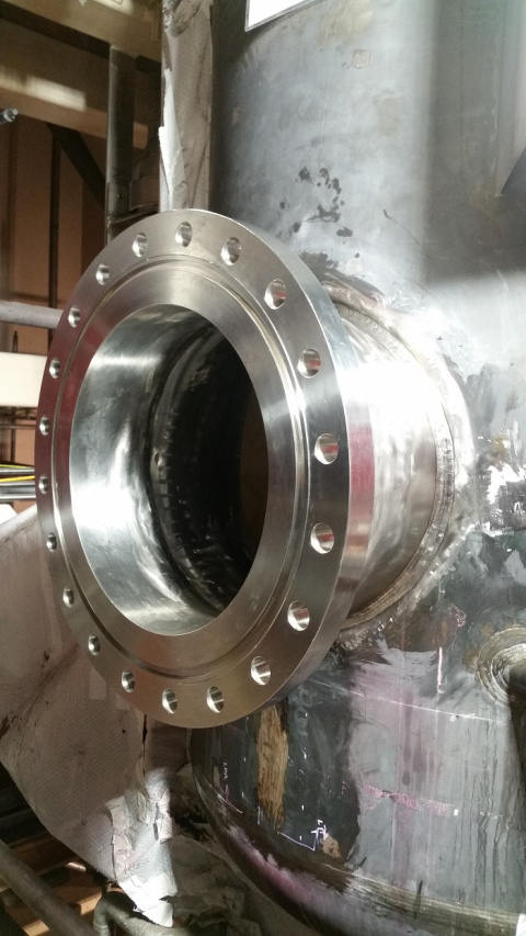 Workers welded a new nozzle to the manway hole of the Denitration Mineralization Reformer to allow entry into the vessel to replace a ring header.