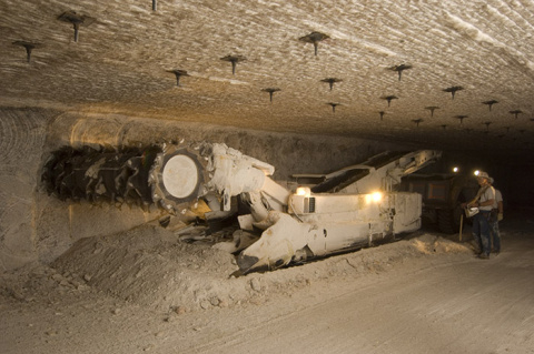 This continuous miner, located underground at the Waste Isolation Pilot Plant, is capable of cutting out salt and depositing it into a vehicle for transport to the surface.