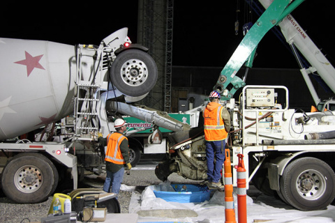 A grout pumping truck places grout into a partially-collapsed storage tunnel to stabilize that tunnel and help ensure employee, public, and environmental safety.