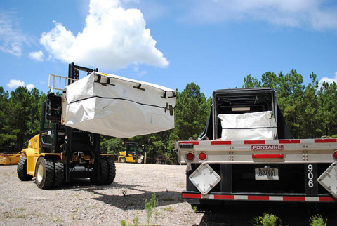 Workers load a container of lead from legacy missions at the Savannah River Site onto a truck to transport to a waste disposal site in Texas.