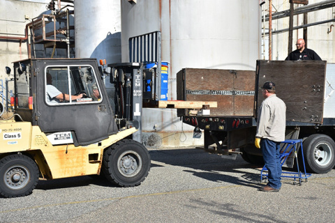 Workers at Hanford’s 222-S Laboratory load a container with tank waste for shipment to Perma-Fix Northwest for treatment and stabilization before being sent to a Texas disposal facility.