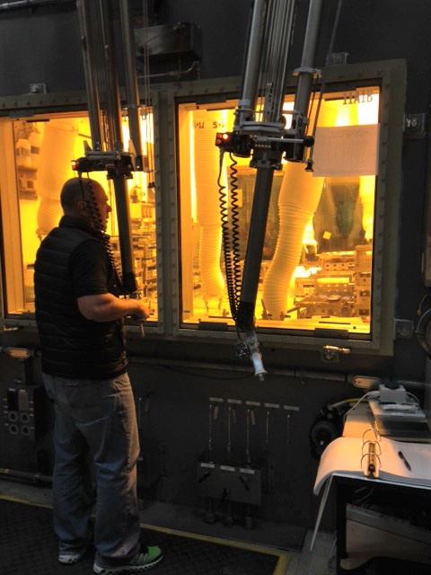 A laboratory technician works remotely with a waste sample in a hot cell at the 222-S Laboratory.
