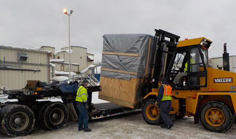 Workers at the West Valley Demonstration Project load the specially designed, robotically operated welder onto a flatbed for shipment to the Hanford Site.