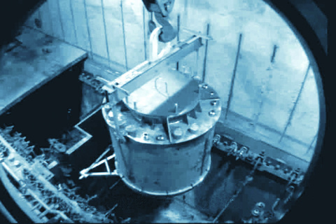 Using a remote-control crane, operators lower a new dissolver into H Canyon. The dissolver helps process two types of spent nuclear fuel at a time.