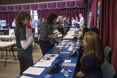 Donna Wendt, left, director of career services at Augusta Technical College, visits the Savannah River National Laboratory’s exhibit at the reverse career fair.
