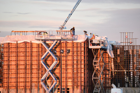 Construction workers place concrete inside formwork and around reinforcing steel during structural concrete wall placements for the Effluent Management Facility at Hanford’s Waste Treatment and Immobilization Plant project.