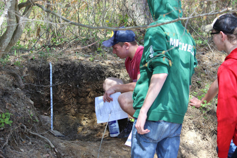 Envirothon participants examine a soil profile at the soils testing station during the competition.