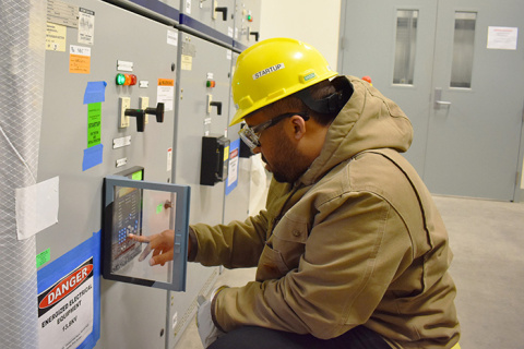 An employee with EM Office of River Protection contractor Bechtel National, Inc. checks an electrical panel in Low-Activity Switchgear Building 24.
