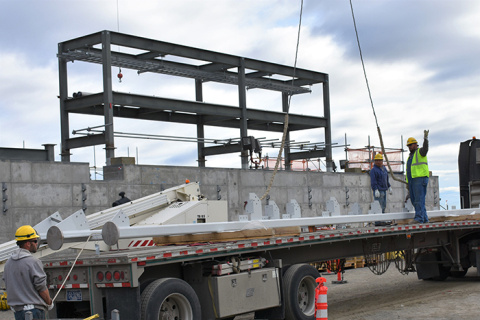 Workers safely unload structural steel for an evaporator equipment tower at Hanford’s Waste Treatment and Immobilization Plant.