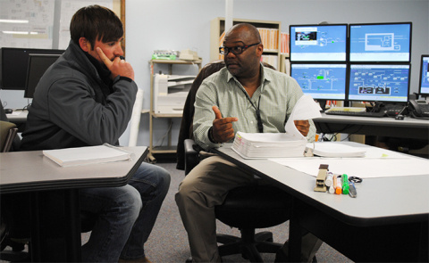 Savannah River Remediation (SRR) Shift Operations Manager Tracy Scott (right) describes Savannah River Site Tank Farm operations to Matt Chassereau, an H Tank Farm Operations first line manager, as part of SRR’s enhanced continuing training.