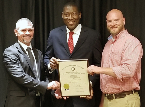 Swift & Staley Team (SST) award presentation, left to right: SST Environment, Safety and Health Manager John Hobbs; Kentucky Labor Secretary Derrick Ramsey; and SST United Steel Workers Safety Representative Jason Gilbert.