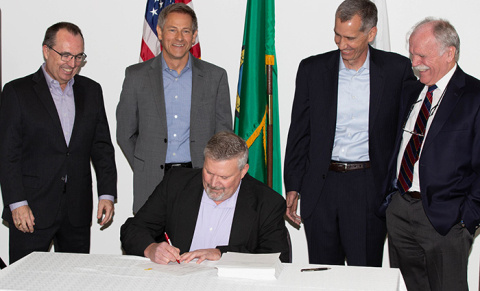 Ben Harp, EM ORP deputy manager, signs a Safety Evaluation Report. From left: Brian Reilly, BNI senior VP & WTP project director; Rob Hastings, ORP assistant manager; Brian Vance, ORP manager; and Alan Dobson, BNI area manager for nuclear safety. Ben Harp, EM Office of River Protection (ORP) deputy manager, signs a Safety Evaluation Report, which recommended approval of the Hanford Low-Activity Waste vitrification facility Documented Safety Analysis.