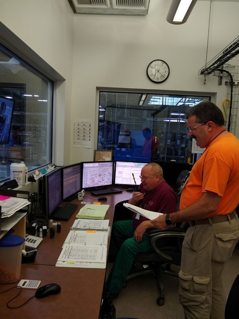Hanford Site workers Tim Malley, seated, and Steve Rust monitor operations of the groundwater treatment program, which recently treated 2.2 billion gallons of groundwater for fiscal year 2018.