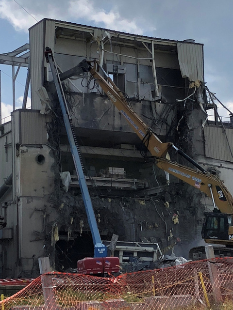 Workers use heavy equipment to take down the penthouse structure from atop the Vitrification Facility. Debris from the project will be size reduced, packaged, and shipped to a disposal facility.