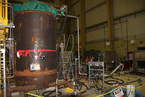 Jeff Akers, CH2M HILL Plateau Remediation Company engineering technician, reviews controls during testing of equipment to remove filters from the K West Reactor Basin at the Hanford Site.