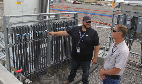 Buddy Cunningham, left, and Marty Doornbos with CH2M HILL Plateau Remediation Company’s soil and groundwater remediation program review components of a system to prevent uranium from reaching the groundwater and nearby Columbia River.