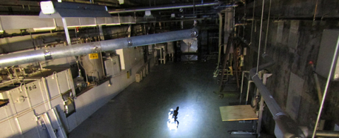 Workers deploy a robotic device to safely investigate and collect data from a potentially hazardous area of a former nuclear processing facility.
