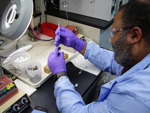 A Wastren Advantage Inc., employee tests a sample of tank waste at the 222-S Laboratory on the Hanford Site.