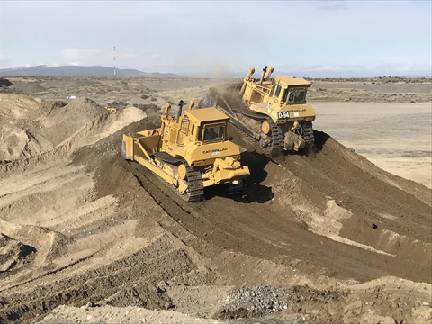 Mission Support Alliance heavy equipment operators used nine dump trucks, two water trucks, three bulldozers, one road grader, one compactor, and one front-end loader to install the cover for the Hanford Solid Waste Landfill.
