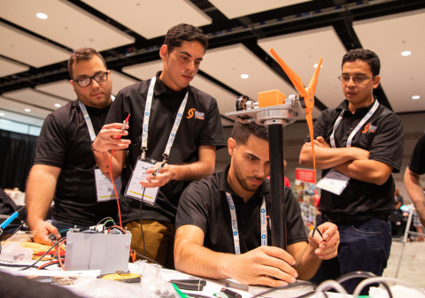 Students work on their wind turbines in their team booths at the Collegiate Wind Competition 2018, in Chicago on May 8, 2018.