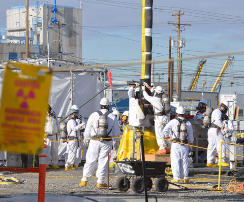 A truck ships the last excavator used in cleanup at the Separations Process Research Unit on Jan. 24.