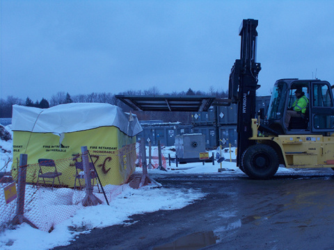 Crews at the West Valley Demonstration Project Site load and move demolition debris from the Vitrification Facility demolition work area.