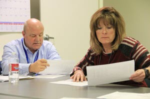 Spent Nuclear Fuel Support Manager Mark Stubblefield and Nuclear Facility Manager Pat Spaulding review maintenance logs of repairs.