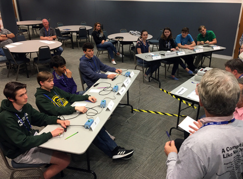DOE Science Bowl teams from Greenbrier High School (foreground) and North Augusta High School, both from South Carolina, make last minute preparations before the next round during a regional competition sponsored by DOE Savannah River.