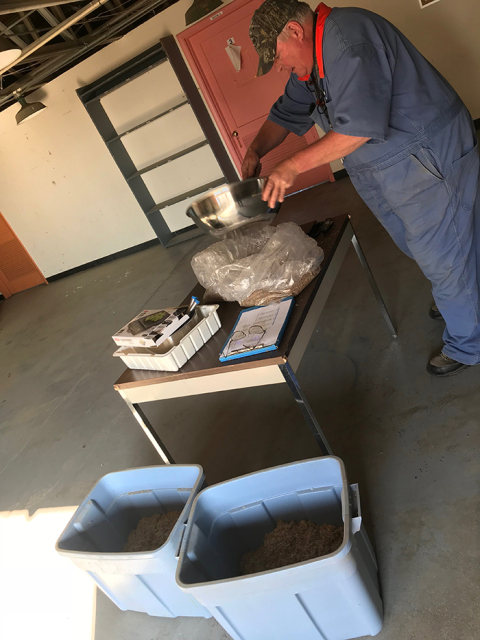 Richard Roos, a Mission Support Alliance environmental scientist, takes great care to weigh and mix seeds for revegetation efforts at the Hanford Site.