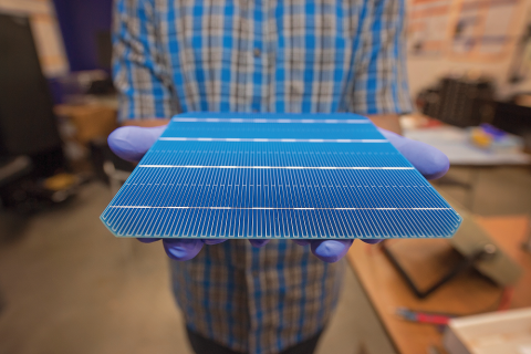 A researcher holds out a silicon solar cell from Pica Solar that uses technology to make the cell more efficient. Engineer Hafeezuddin Mohammed with a Picasolar enhanced industrial n-type solar cell