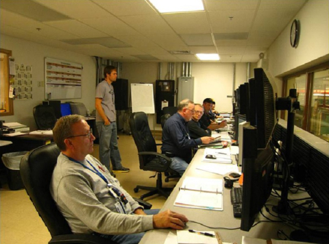 Depleted Uranium Hexafluoride Conversion Project technicians monitor conversion facilities from a plant control room.