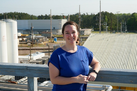 Christina Santos stands in front of the Modular Caustic Side Solvent Extraction Unit at the Savannah River Site.