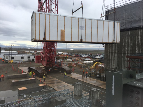 Workers at Hanford’s Waste Treatment and Immobilization Plant safely lower the first of three sections of a 111-ton electrical powerhouse for the plant’s Effluent Management Facility.