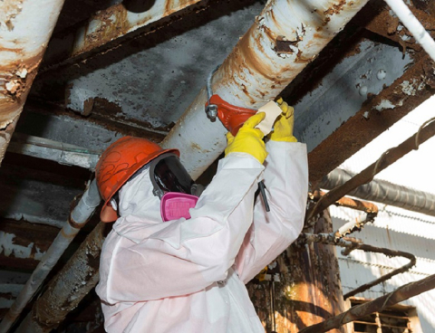 A worker installs a “hot tap,” which allows crews to connect to existing piping without spilling its contents. 