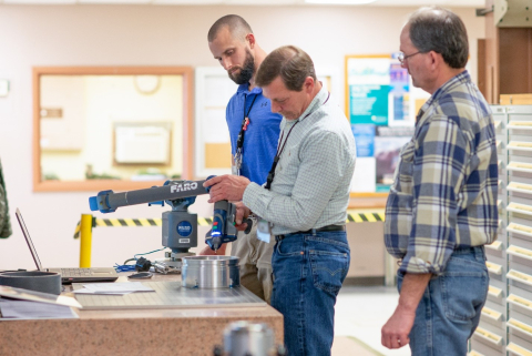 Chris Hall, left, Kerek Bearden, center, and Pete Hadden with the Savannah River Nuclear Solutions quality assurance division demonstrate the capabilities of a new probing and laser scanning device.